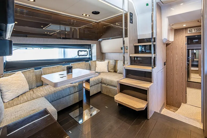 Slide: The Image of Luxurious interior of 2019 Azimut Atlantis 51 yacht with modern seating and wooden staircase. - 32