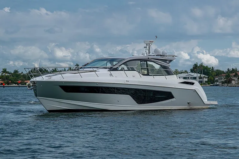 Slide: The Image of 2019 Azimut Atlantis 51 yacht cruising on a calm, scenic waterway. - 4