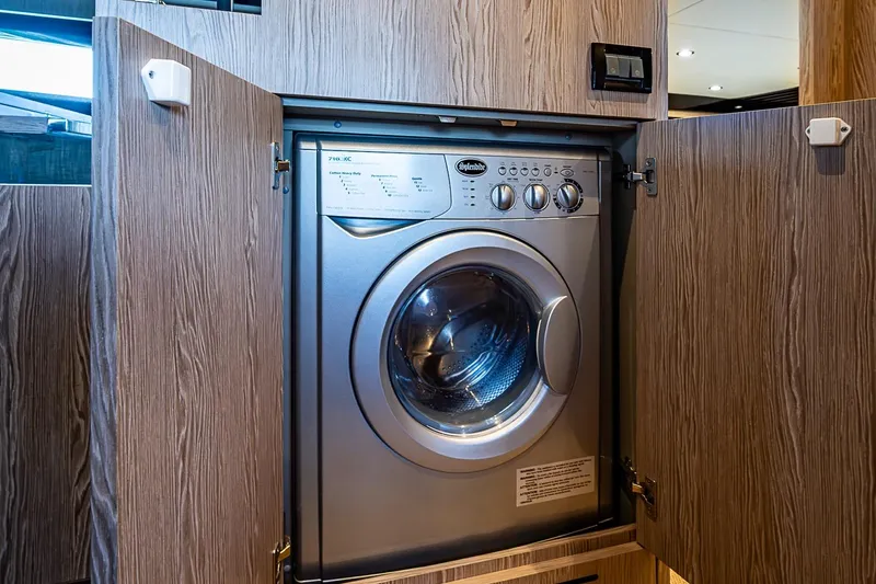 Slide: The Image of Built-in washing machine on 2019 Azimut Atlantis 51 yacht, enclosed in wooden cabinetry. - 40