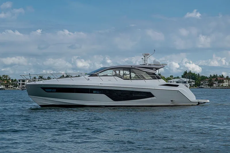 Slide: The Image of 2019 Azimut Atlantis 51 yacht cruising on a calm, scenic waterway. - 5