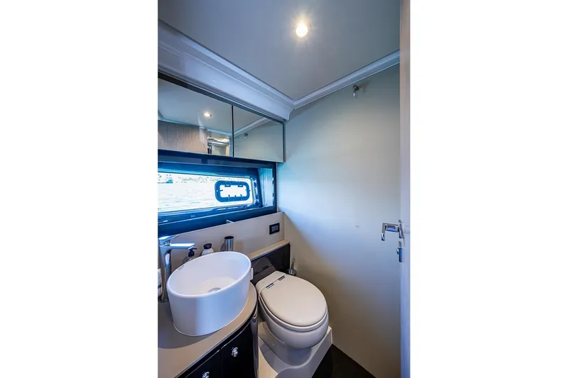 Slide: The Image of Luxurious bathroom interior of 2019 Azimut Atlantis 51 yacht, featuring modern fixtures and window. - 54