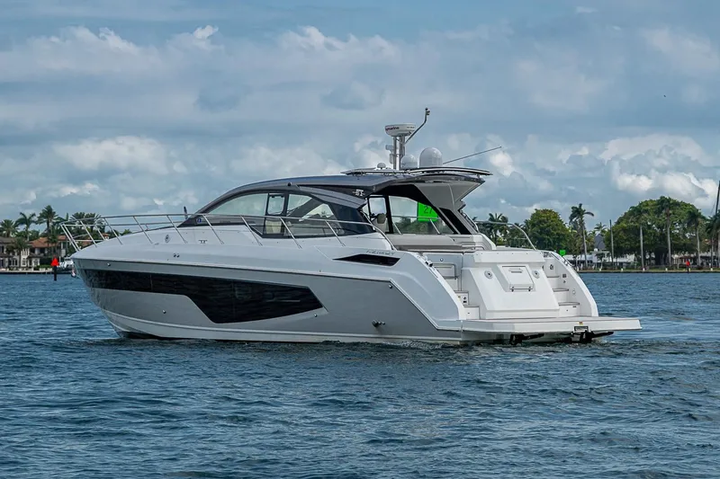 Slide: The Image of 2019 Azimut Atlantis 51 yacht cruising on a calm, scenic waterway. - 6