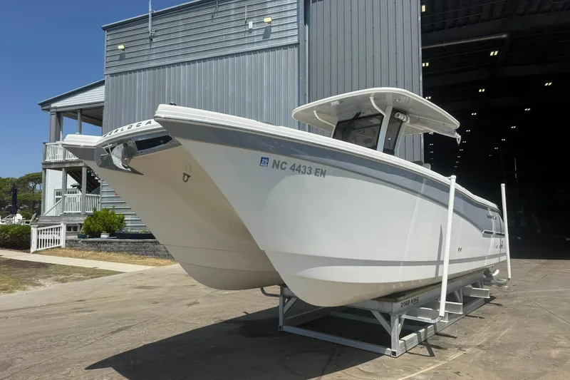 The Image of 2020 World Cat 280 CC-X boat on trailer outside a large building. - 1