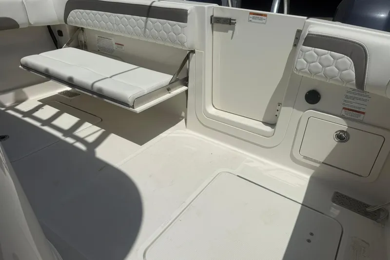 Slide: The Image of 2020 World Cat 280 CC-X boat interior with foldable seating and storage compartments. - 10