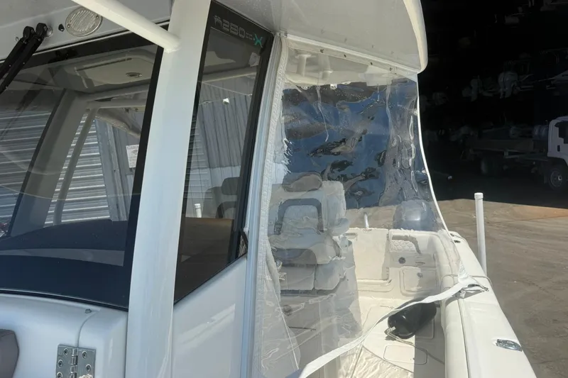 Slide: The Image of 2020 World Cat 280 CC-X boat with clear protective cover and seating area. - 16