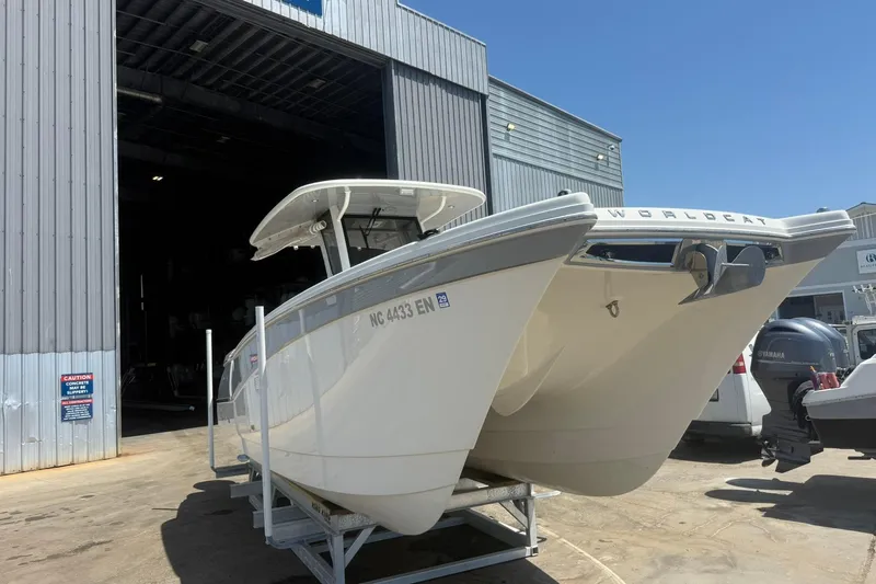 Slide: The Image of 2020 World Cat 280 CC-X boat on trailer outside a large warehouse. - 27