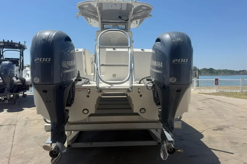 Slide: The Image of 2020 World Cat 280 CC-X boat with dual Yamaha 200 engines, docked by the water. - 4
