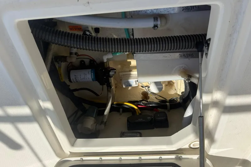 Slide: The Image of 2020 World Cat 280 CC-X boat compartment with visible wiring and components. - 9