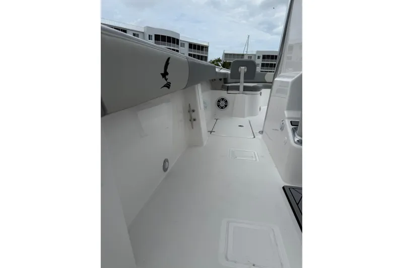 Slide: The Image of Interior view of 2026 Falcon Boats 26, featuring sleek white deck and seating. - 11