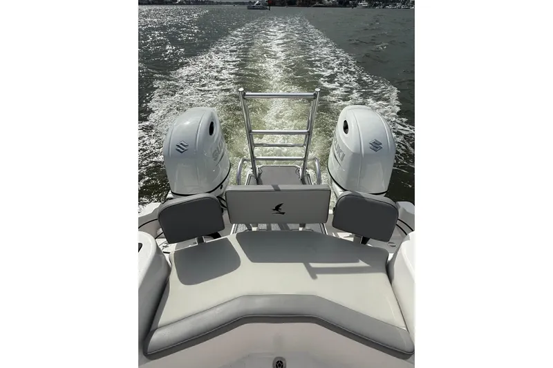 Slide: The Image of 2026 Falcon Boats 26 with dual Suzuki outboard engines cruising on open water. - 3