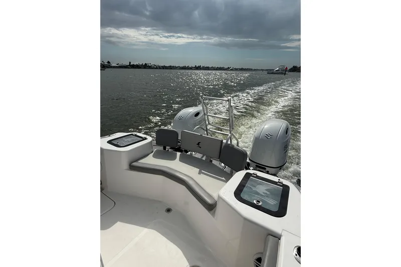 Slide: The Image of 2026 Falcon Boats 26 cruising on a sunny day, showcasing dual engines and sleek design. - 6