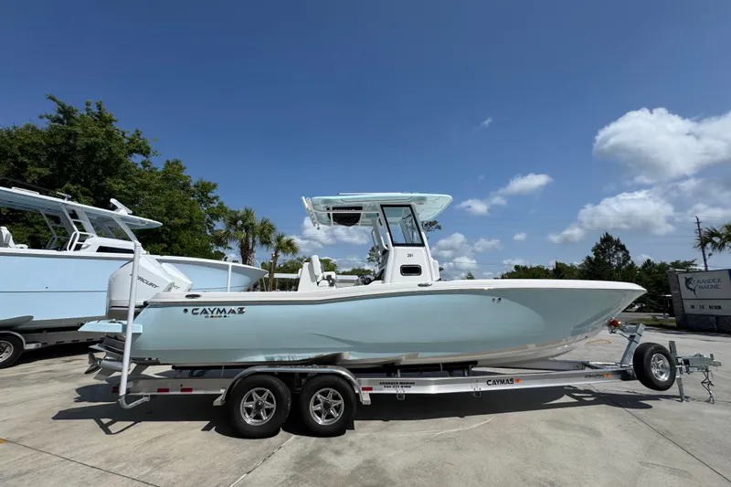 Slide: The Image of 2026 Caymas 291 boat on trailer under clear blue sky. - 10