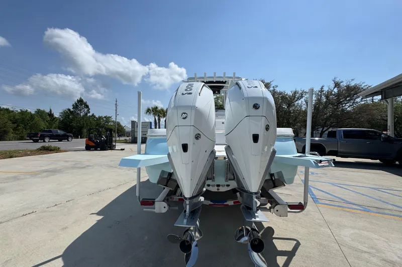 Slide: The Image of 2026 Caymas 291 boat with dual outboard engines in a sunny outdoor setting. - 14