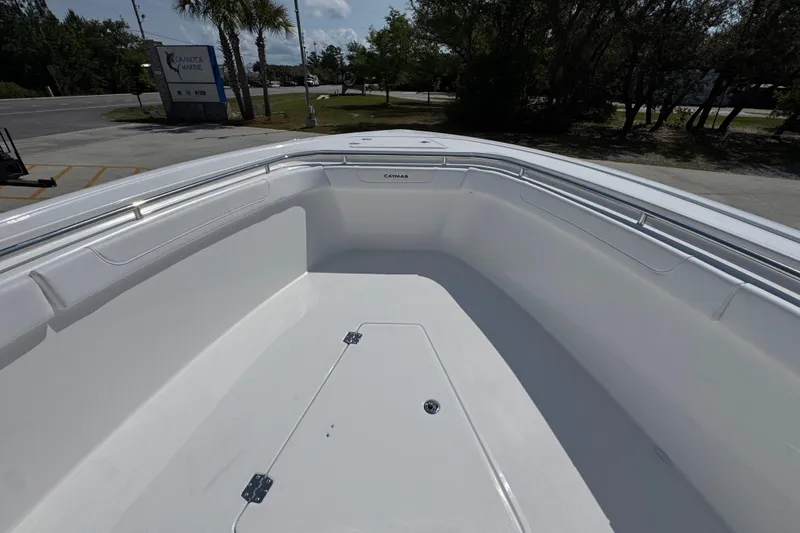 Slide: The Image of 2026 Caymas 291 boat deck, spacious and sleek design, parked at a marina. - 18