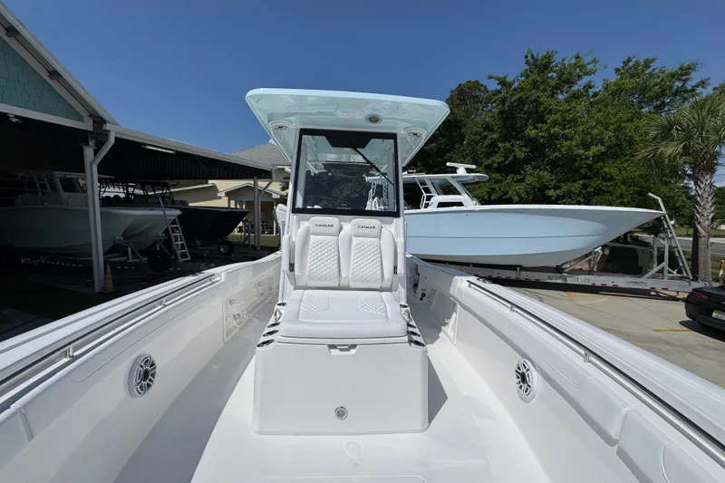 Slide: The Image of 2026 Caymas 291 boat with sleek white interior and modern design, docked outdoors. - 22