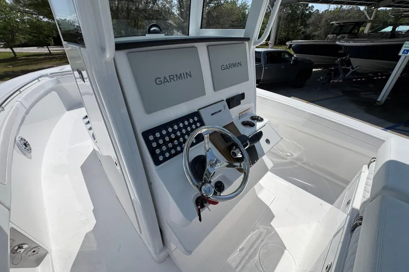 Slide: The Image of 2026 Caymas 291 boat cockpit with Garmin displays and steering wheel. - 28