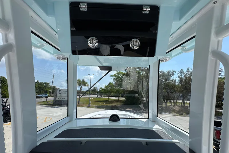 Slide: The Image of Interior view of 2026 Caymas 291 boat showcasing windows and overhead storage. - 31