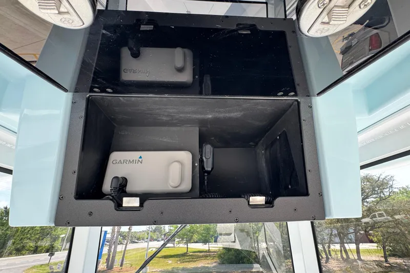 Slide: The Image of 2026 Caymas 291 boat electronics compartment with Garmin device. - 32