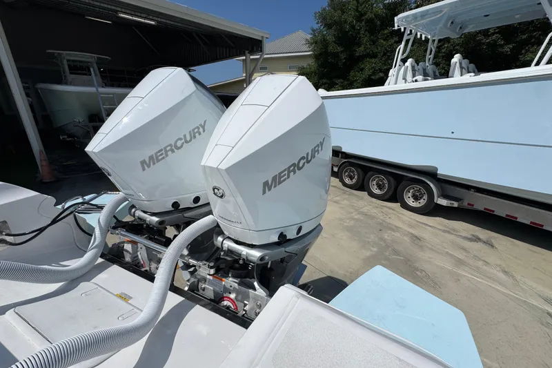 Slide: The Image of Twin Mercury outboard engines on a 2026 Caymas 291 boat, parked on a trailer. - 36
