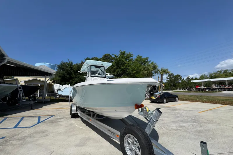 Slide: The Image of 2026 Caymas 291 boat on trailer in sunny outdoor setting. - 7