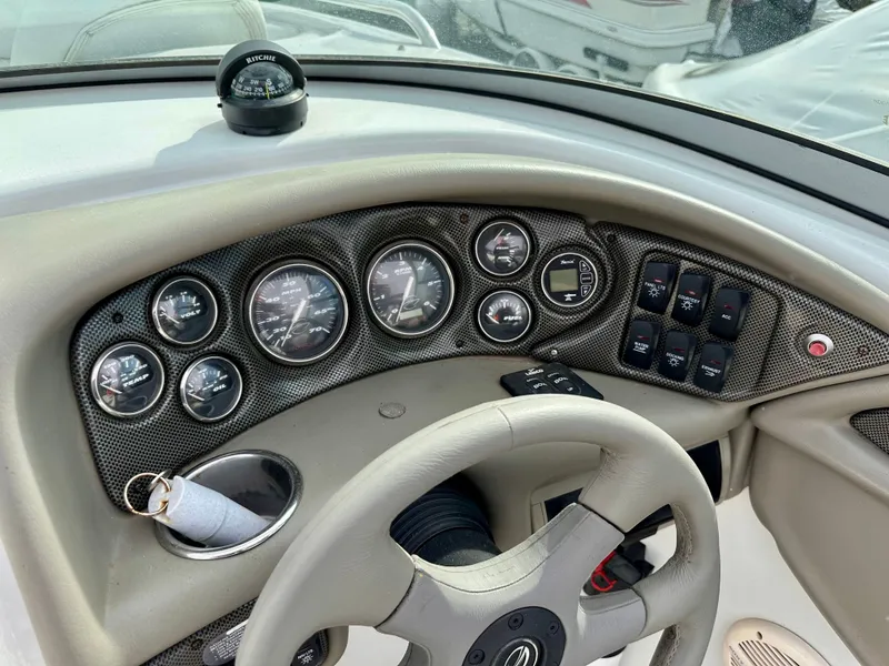 Slide: The Image of Dashboard of a 2005 Crownline 270 BR boat with compass and gauges. - 20