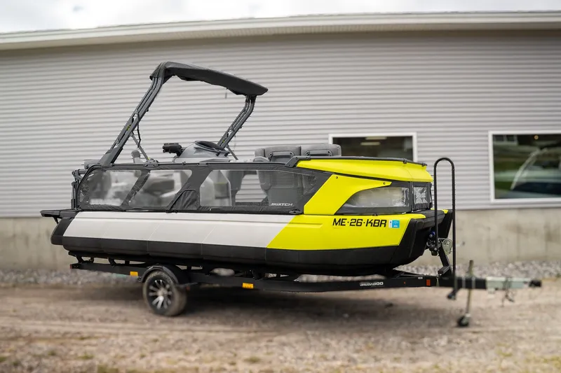 Slide: The Image of 2024 Sea-Doo Switch Cruise on trailer in front of building. - 4