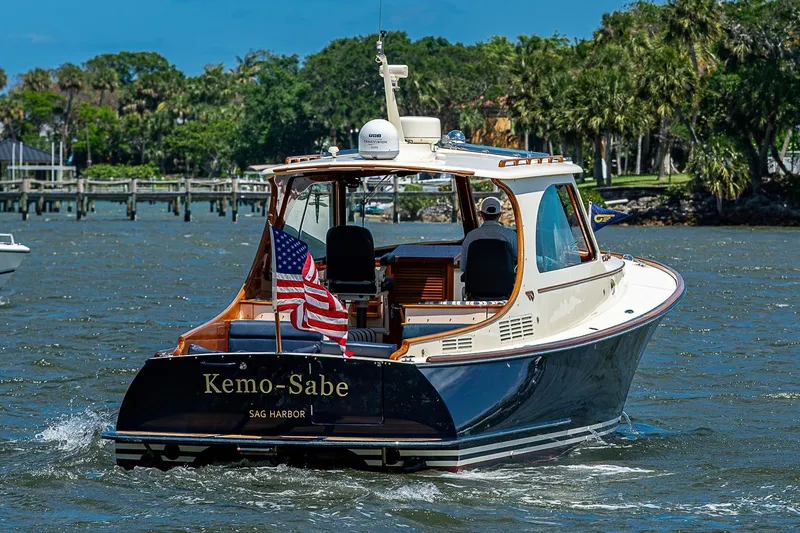 The Image of 2013 Hinckley Picnic Boat 37 MKIII cruising on a sunny day, displaying an American flag. - 0