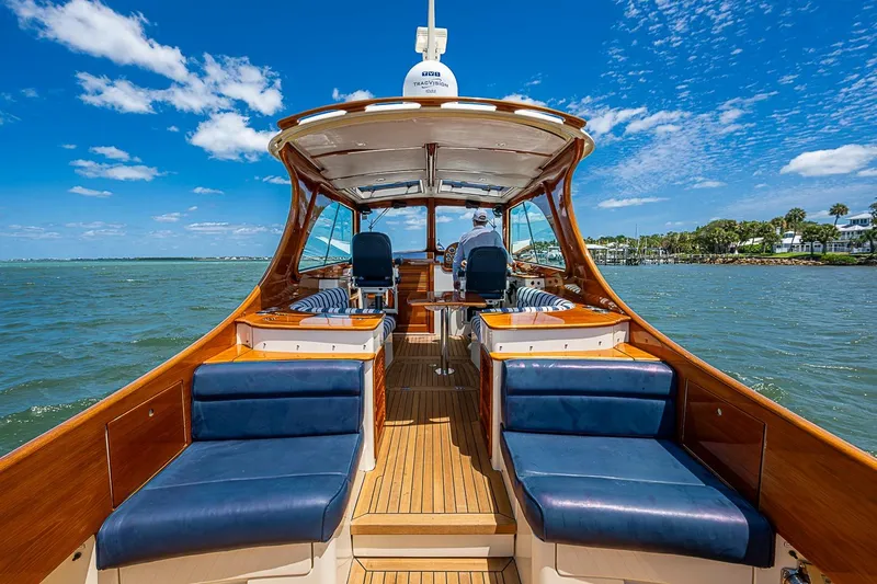 Slide: The Image of 2013 Hinckley Picnic Boat 37 MKIII cruising on a sunny day, featuring elegant wooden interiors. - 10