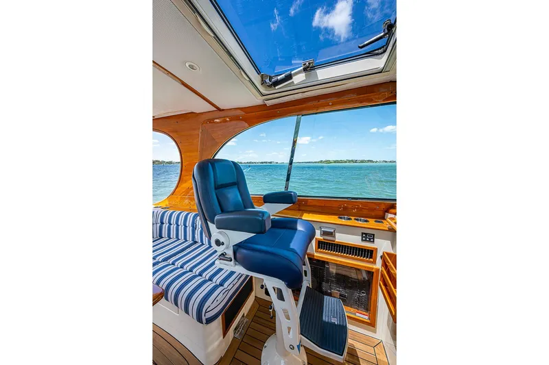 Slide: The Image of Interior of 2013 Hinckley Picnic Boat 37 MKIII with blue captain's chair and ocean view. - 11