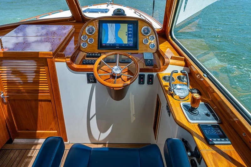 Slide: The Image of Hinckley Picnic Boat 37 MKIII 2013 helm with wooden dashboard and navigation controls. - 13