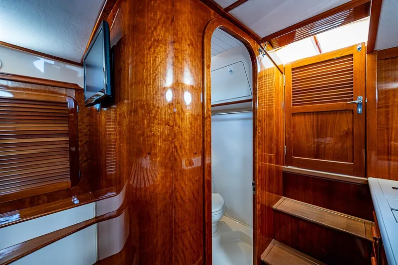 Slide: The Image of Luxurious wooden interior of 2013 Hinckley Picnic Boat 37 MKIII with elegant cabinetry and stairs. - 14