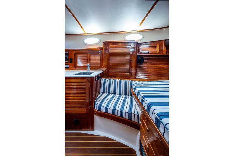 Slide: The Image of Interior of 2013 Hinckley Picnic Boat 37 MKIII with wood finish and striped seating. - 17