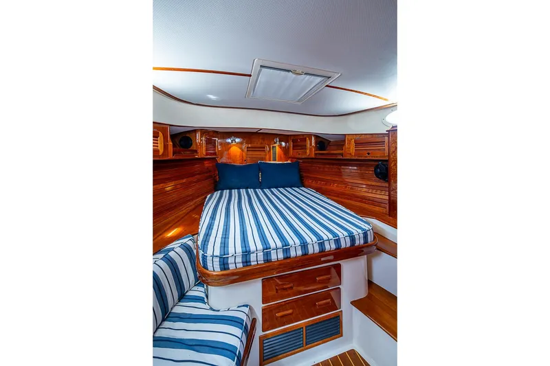 Slide: The Image of Luxurious cabin interior of 2013 Hinckley Picnic Boat 37 MKIII with striped bedding. - 18