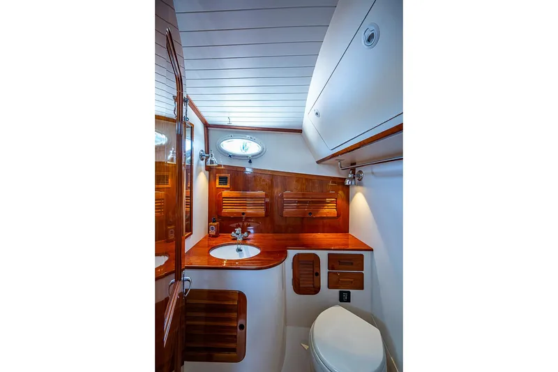 Slide: The Image of Luxurious 2013 Hinckley Picnic Boat 37 MKIII bathroom with elegant wood finishes. - 19