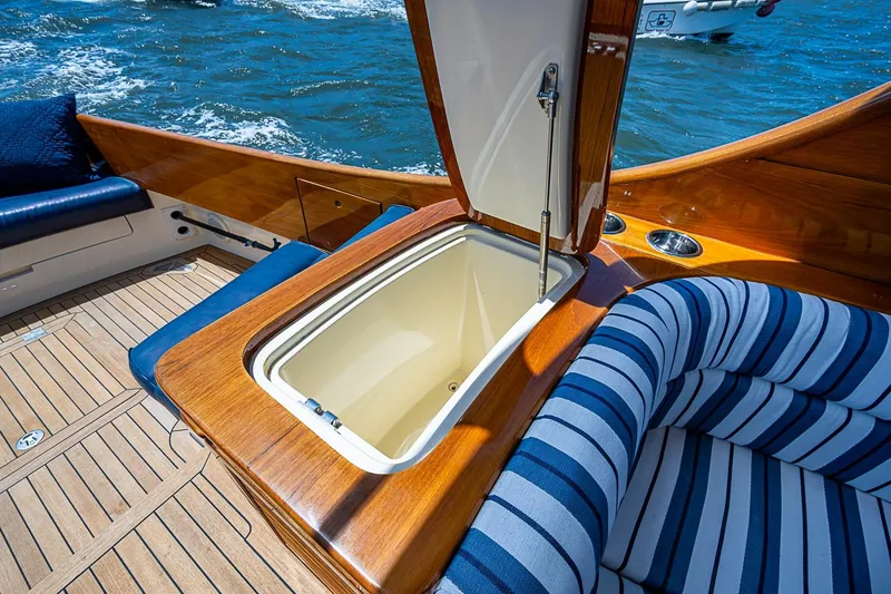 Slide: The Image of Luxurious 2013 Hinckley Picnic Boat 37 MKIII with elegant wood finish and striped seating. - 6