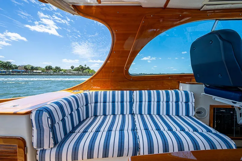 Slide: The Image of Interior of 2013 Hinckley Picnic Boat 37 MKIII with striped seating and scenic water view. - 7
