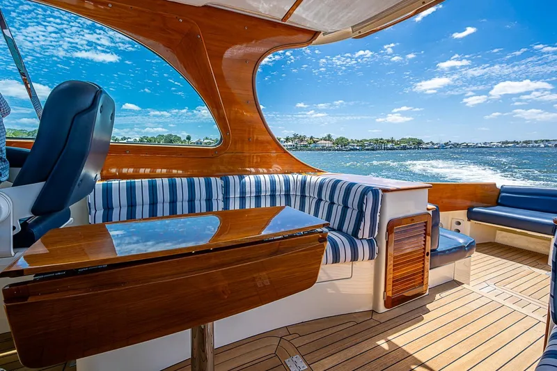 Slide: The Image of Luxurious interior of 2013 Hinckley Picnic Boat 37 MKIII with striped seating and wooden finishes. - 9