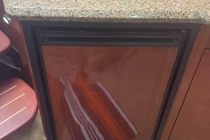 Slide: The Image of Wood-paneled refrigerator in 2006 Sea Ray 380 Sundancer yacht kitchen. - 12