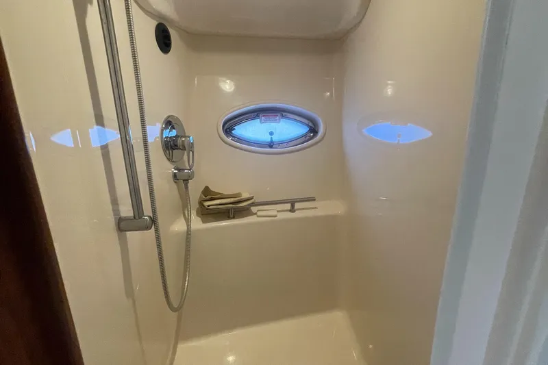Slide: The Image of Shower area in 2006 Sea Ray 380 Sundancer yacht with porthole window. - 13