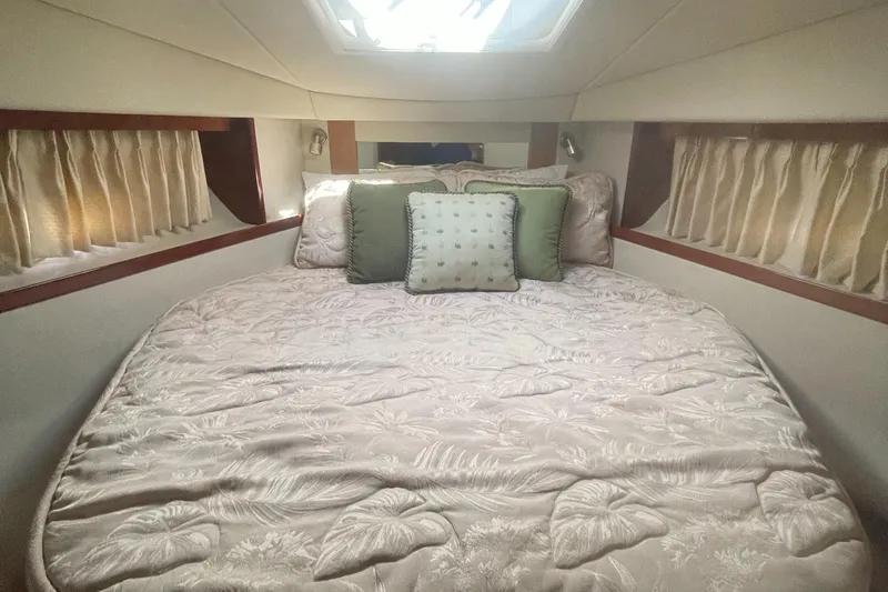 Slide: The Image of Luxurious cabin interior of 2006 Sea Ray 380 Sundancer yacht with plush bedding. - 15