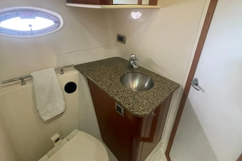 Slide: The Image of 2006 Sea Ray 380 Sundancer bathroom with granite countertop and stainless steel sink. - 16