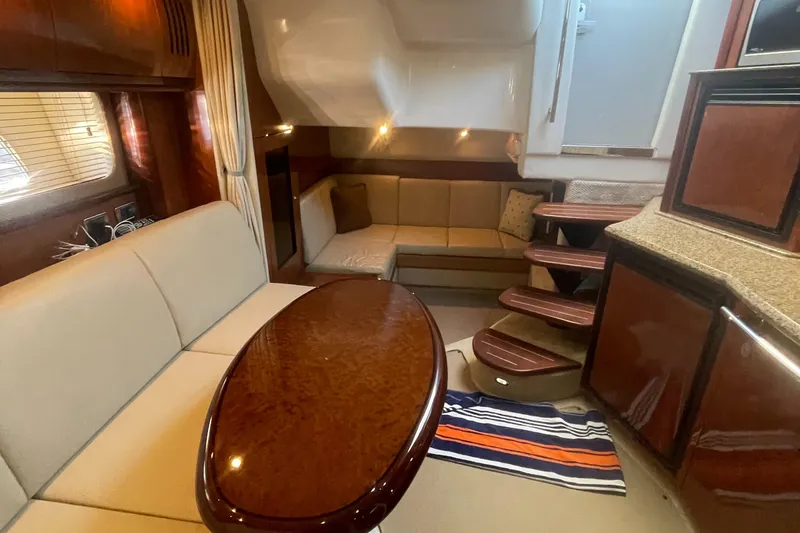 Slide: The Image of Luxurious interior of 2006 Sea Ray 380 Sundancer yacht with elegant seating and wooden finishes. - 17