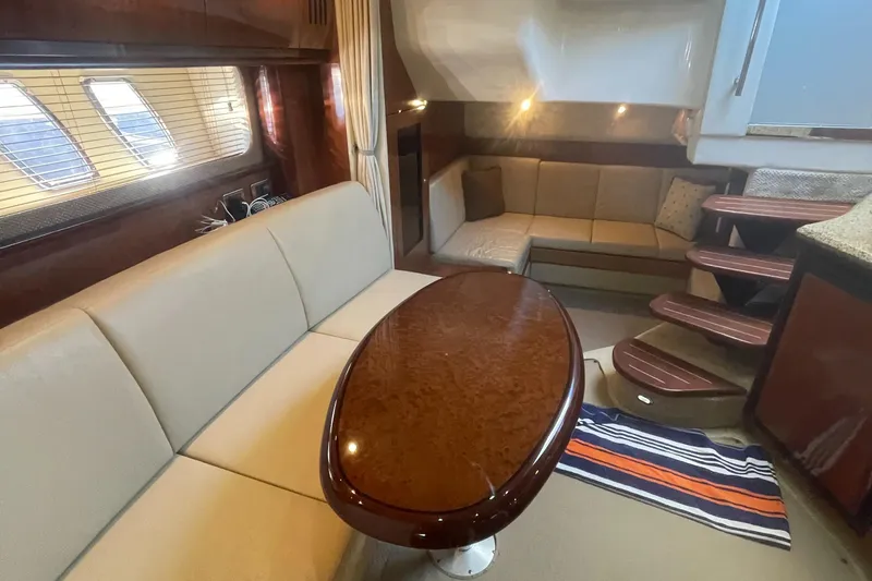 Slide: The Image of Luxurious interior of 2006 Sea Ray 380 Sundancer yacht with elegant seating and wooden table. - 18