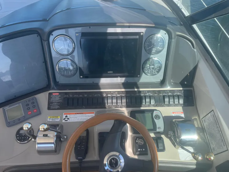 Slide: The Image of Control panel of a 2006 Sea Ray 380 Sundancer boat with gauges and navigation equipment. - 2