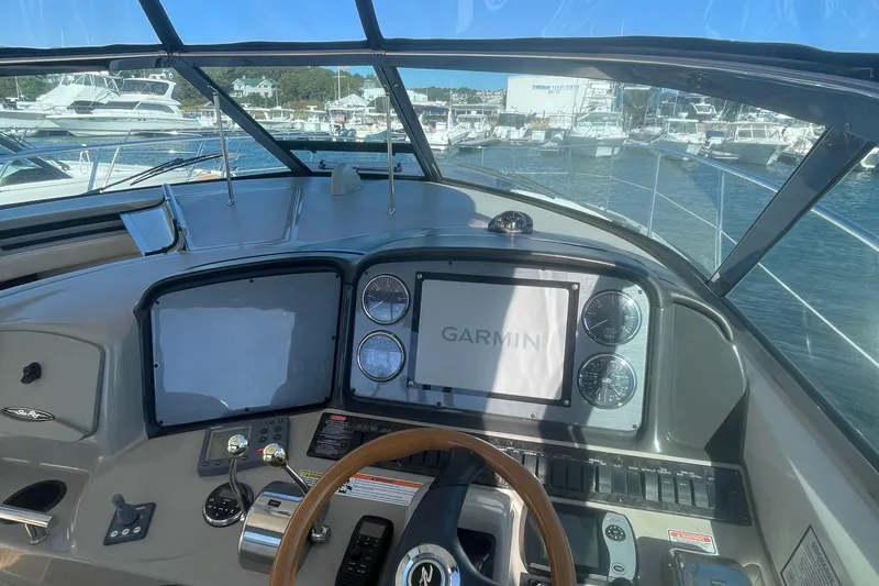 Slide: The Image of Helm of 2006 Sea Ray 380 Sundancer with Garmin navigation system, docked at marina. - 24
