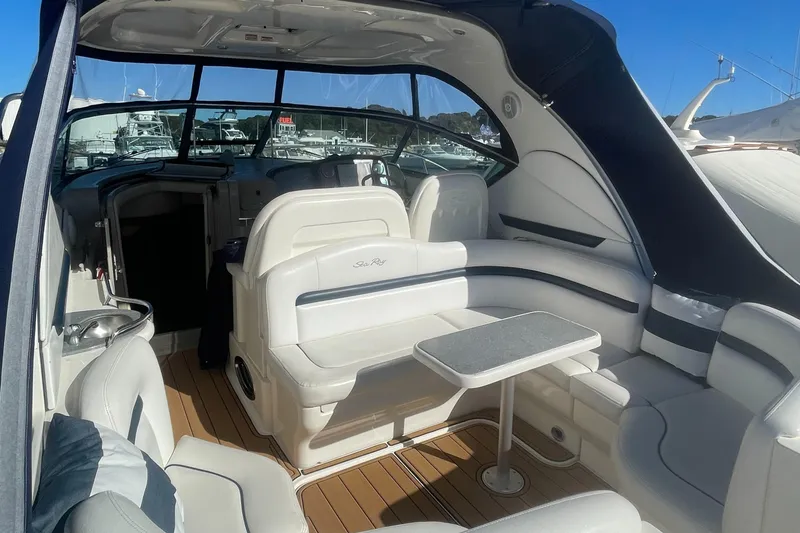 Slide: The Image of 2006 Sea Ray 380 Sundancer yacht interior with seating and table, featuring sleek design. - 29