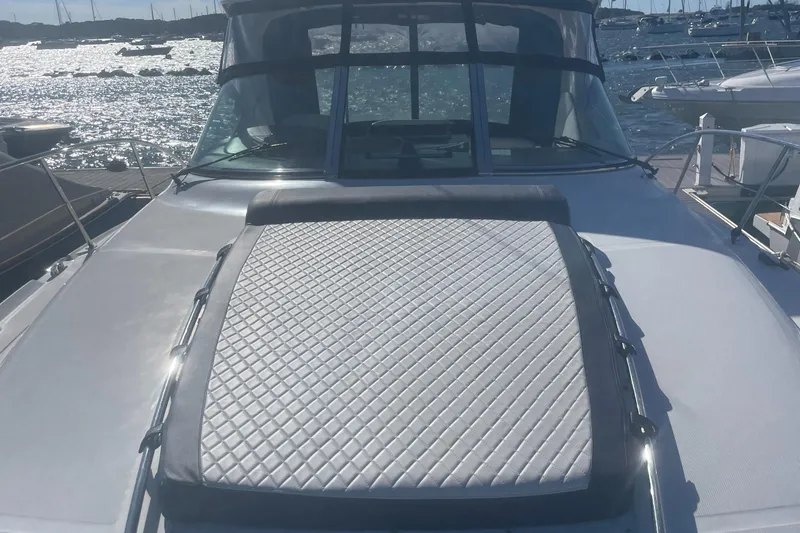 Slide: The Image of 2006 Sea Ray 380 Sundancer yacht with sun pad, docked by the water. - 30