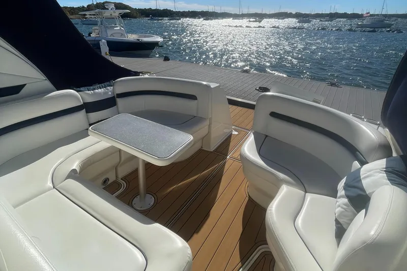 Slide: The Image of Luxurious 2006 Sea Ray 380 Sundancer yacht interior with elegant seating and table, overlooking serene waters. - 33