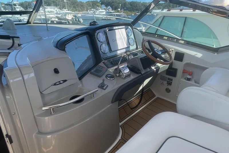 Slide: The Image of Helm of 2006 Sea Ray 380 Sundancer with modern navigation equipment and wooden steering wheel. - 4
