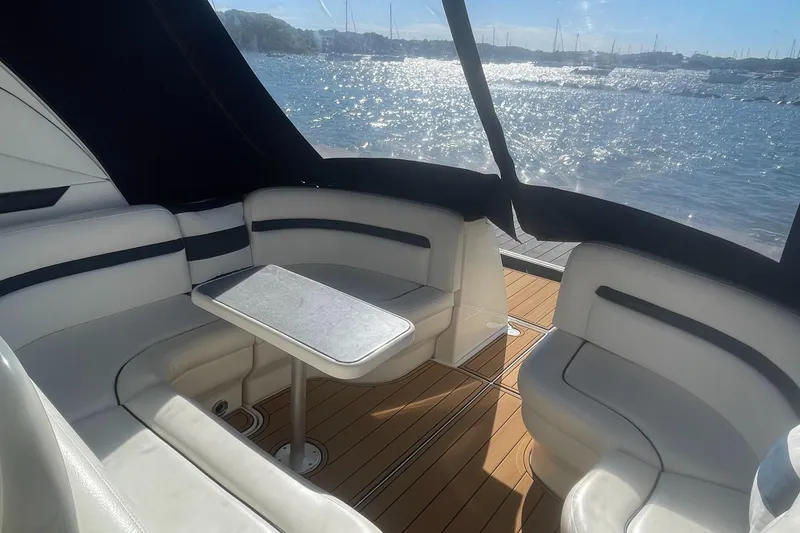 Slide: The Image of Luxurious 2006 Sea Ray 380 Sundancer yacht interior with elegant seating and scenic water view. - 5